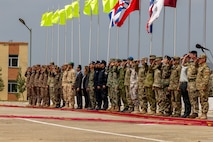 Multinational distinguished guests render honors during the closing ceremony of Khaan Quest 2025, on June 28, 2025, at Five Hills Training Area.
