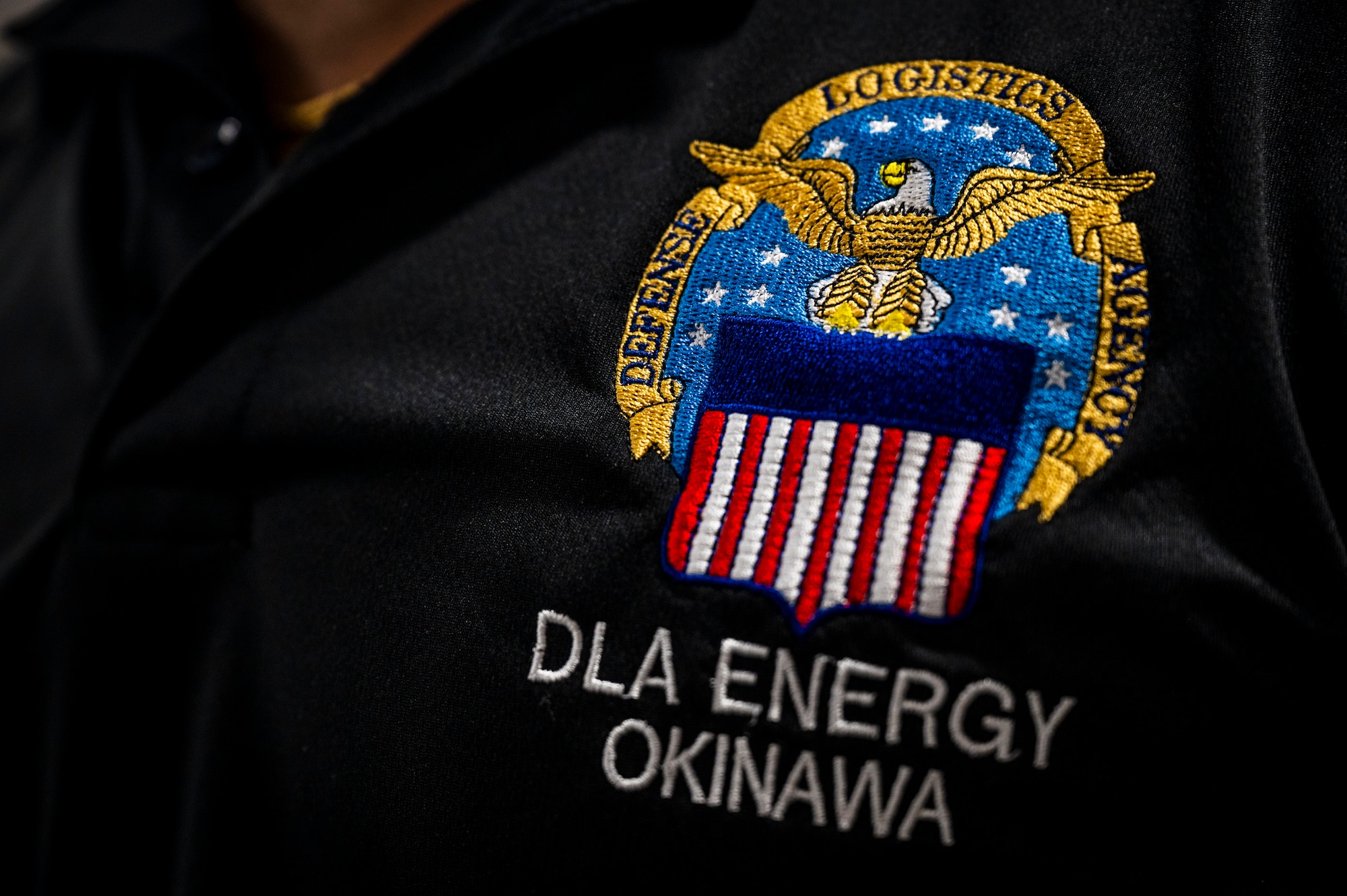 A Defense Logistics Agency Energy Okinawa embroidered shirt is worn by an employee of DLA Energy Okinawa near Kadena Air Base, Japan, July 2, 2025.