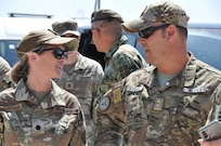 A group of service members talking.
