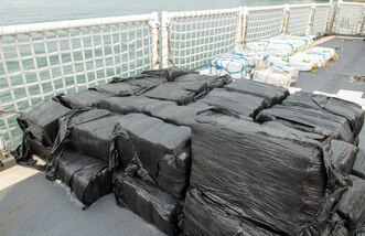Illicit drugs sit on a flight deck of a Coast Guard cutter