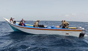 Coast Guard law enforcement officers apprehend a suspected drug smuggling vessel