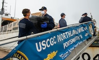 Coast Guard members offload illicit drugs