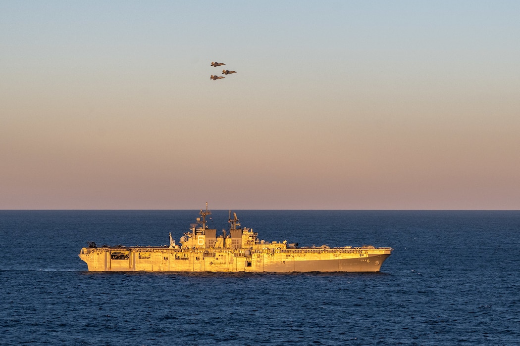 CORAL SEA (July 1, 2025) Three U.S. Marine Corps F-35B Lightning II aircraft, assigned to Marine Fighter Attack Squadron (VMFA) 242, 31st Marine Expeditionary Unit, fly by the forward-deployed amphibious assault ship USS America (LHA 6) while conducting flight operations in the Coral Sea, July 1. The America, lead ship of the America Amphibious Ready Group, is operating in the U.S. 7th Fleet area of operations. U.S. 7th Fleet is the U.S. Navy’s largest forward-deployed numbered fleet, and routinely interacts and operates with allies and partners in preserving a free and open Indo-Pacific region. (U.S. Navy photo illustration by Mass Communication Specialist 3rd Class Kenneth Melseth)