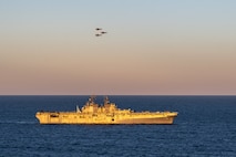 CORAL SEA (July 1, 2025) Three U.S. Marine Corps F-35B Lightning II aircraft, assigned to Marine Fighter Attack Squadron (VMFA) 242, 31st Marine Expeditionary Unit, fly by the forward-deployed amphibious assault ship USS America (LHA 6) while conducting flight operations in the Coral Sea, July 1. The America, lead ship of the America Amphibious Ready Group, is operating in the U.S. 7th Fleet area of operations. U.S. 7th Fleet is the U.S. Navy’s largest forward-deployed numbered fleet, and routinely interacts and operates with allies and partners in preserving a free and open Indo-Pacific region. (U.S. Navy photo illustration by Mass Communication Specialist 3rd Class Kenneth Melseth)