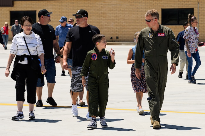 Dylan, Lt. Col. Johnson and guests walking on the airfield ramp.