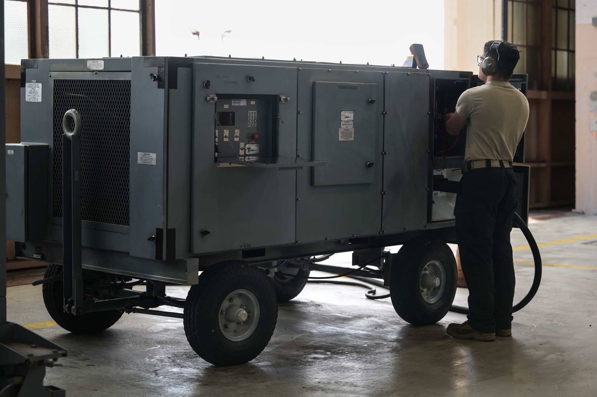 Airman using a load bank to test a generator.