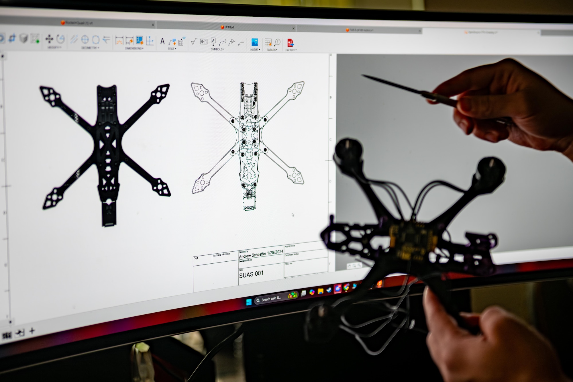 U.S. Air Force Tech. Sgt. Andrew Schaeffer, 35th Cargo Deployment Function innovation noncommissioned officer in charge, showcases the design of a 3D-printed unmanned aerial vehicle training aid.