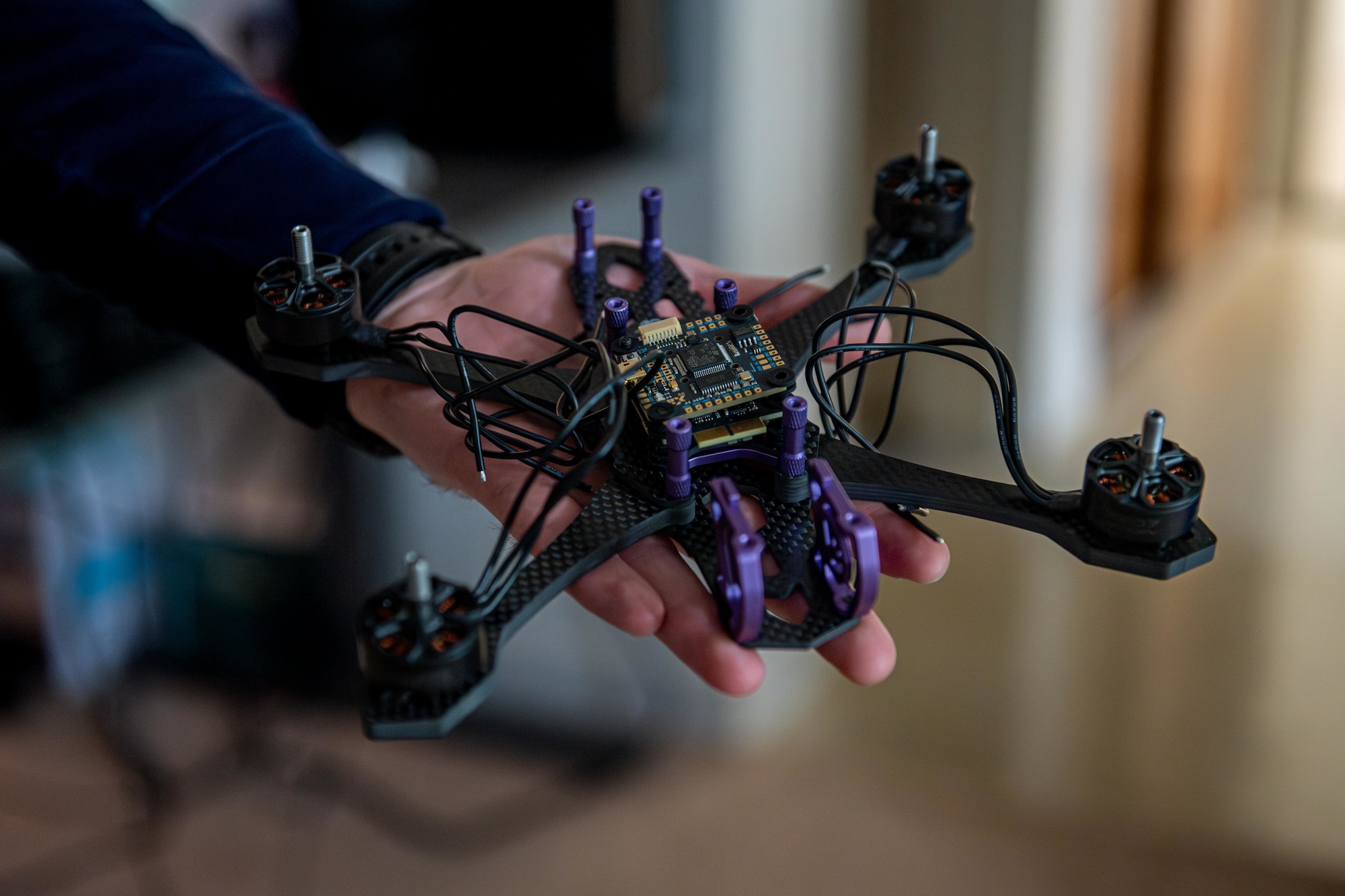 U.S. Air Force 1st Lt. Isaac Loring, lead Project Arc engineer assigned to the Innovation Lab, displays a 3D-printed unmanned aerial vehicle training aid.