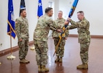 Incoming commander for the Defense Logistics Agency’s U.S. Central Command and U.S. Special Operations region Army Col. Edward Runyan accepts the flag from DLA Director of Logistics Operations Air Force Maj. Gen. David Sanford