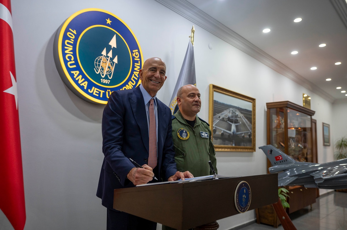 Ambassador Thomas Barrack, left, U.S. Ambassador to Türkiye, signs the 10th Main Jet Base Command visitor honor book during a distinguished visitor tour at Incirlik Air Base, Türkiye, July 1, 2025. On his first visit to Incirlik Air Base, Barrack received a wing mission brief, toured key areas of the installation, and recognized U.S. personnel for their support to the mission, emphasizing the importance of continued cooperation between U.S. and Turkish counterparts in advancing regional stability. (U.S. Air Force photo by Staff Sgt. Koby I. Saunders)