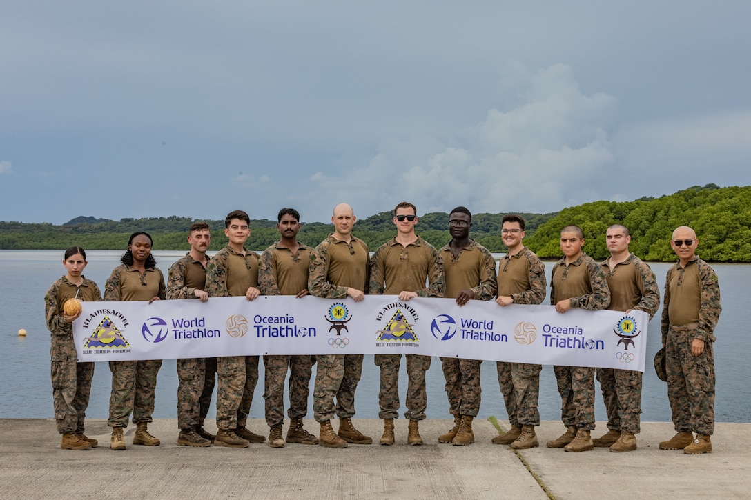 U.S. Marines and Sailors with Combat Logistics Battalion 15, Combat Logistics Regiment 17, 1st Marine Logistics Group, pose for a group photo after providing support for the triathlon time trial held in preparation for the Pacific Mini Games during Koa Moana 25 on Ngiwal, Palau, June 21, 2025.