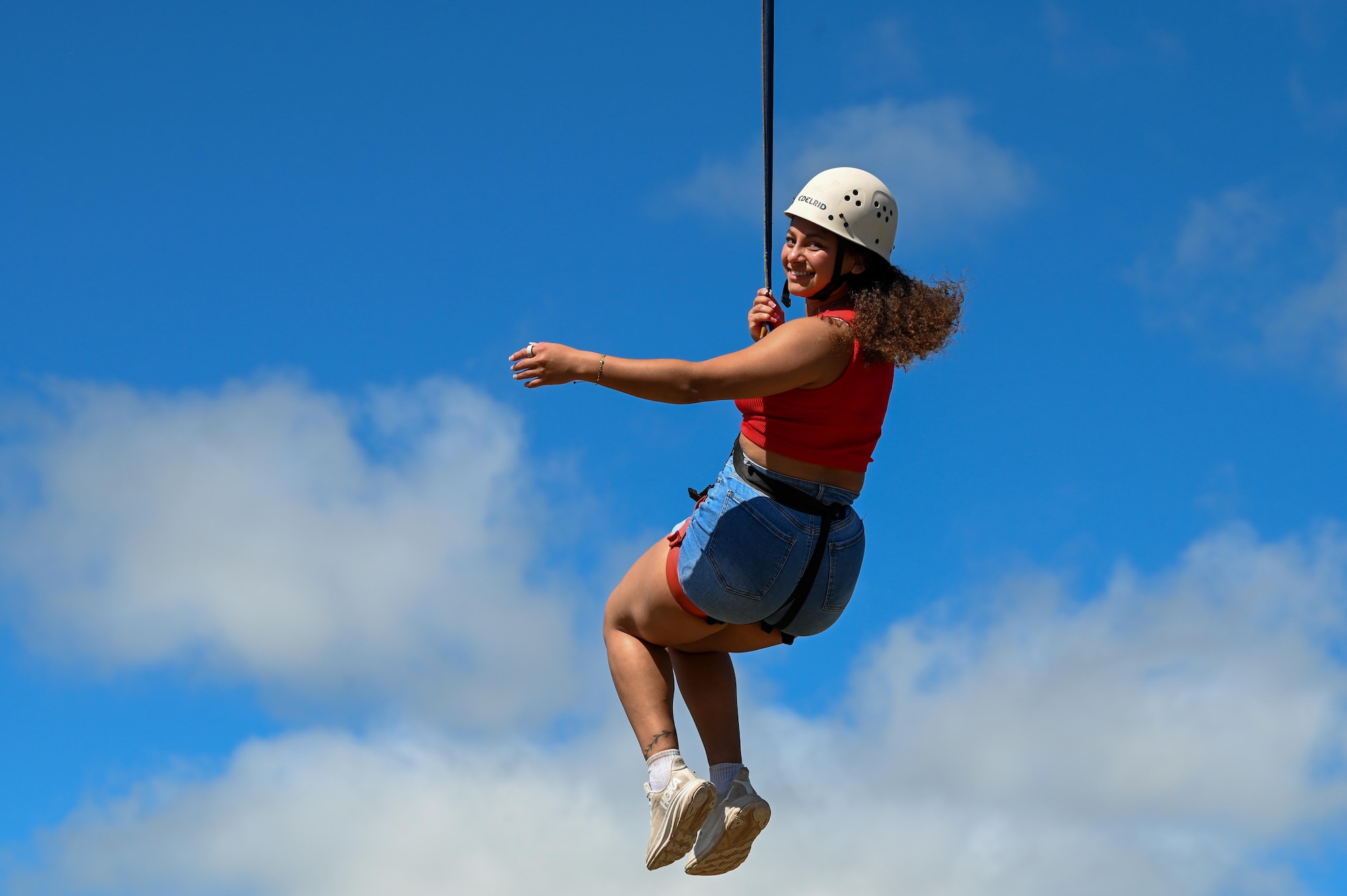 U.S. Air Force Airman 1st Class Ashley Cerna, 7th Logistics Readiness Squadron fleet management analysis journeyman, ziplines during a resiliency retreat at Camp Butman, Texas, June 21, 2025.  Airmen from Dyess Air Force Base participated in recreational activities during the weekend retreat, hosted by the Dyess AFB Chapel, to reinforce spiritual resiliency. (U.S. Air Force photo by Airman 1st Class Adrien Tran)