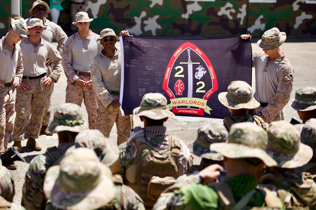 U.S. Marines with 2nd Battalion, 2nd Marine Regiment present a signed insignia flag to their Panamanian counterparts during the second training iteration with the National Aeronaval Service of Panama in Panama, June 26, 2025. The Marines and Panama’s forces spent several weeks training together on topics such as live-fire, medical care, jungle training and survival, and land navigation tactics. (U.S. Marine Corps photo by Sgt. Samuel Qin)