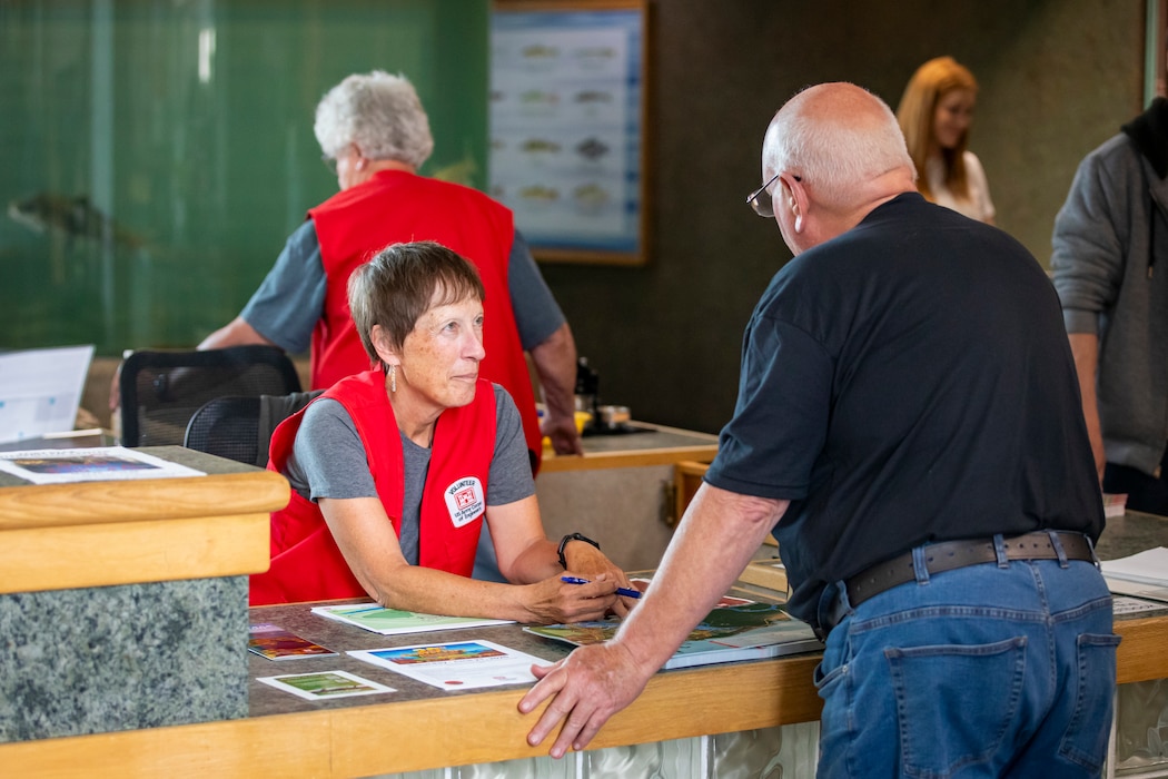 Linda Parpart, a third-year volunteer at the U.S. Army Corps of Engineers’ Fort Peck Interpretive Center and Museum in Fort Peck, Montana, helps answer questions by visitors, June 21, 2025, during its 20th anniversary celebration.