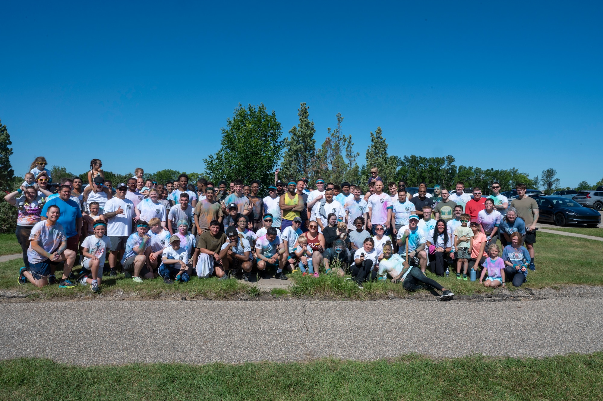 Airmen from the 891st Missile Security Forces squadron pose for a group photo after the Mental Health color run at Minot Air Force Base, North Dakota, June 30, 2025. The run helps build community support reminding everyone they're not alone in their struggles.