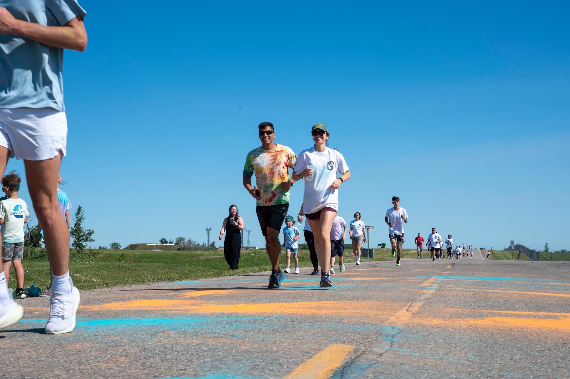 A group of Airmen assigned to the 891st Missile Security Forces squadron run in the Mental Health color run at Minot Air Force Base, North Dakota, June 30, 2025. The run encourages movement, connection and a healthy lifestyle.