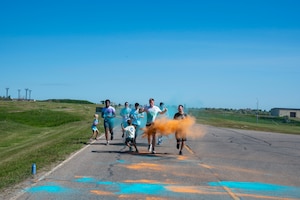 A group of Airmen assigned to the 891st Missile Security Forces squadron run in the Mental Health color run at Minot Air Force Base, North Dakota, June 30, 2025. The run encourages movement, connection and a healthy lifestyle.