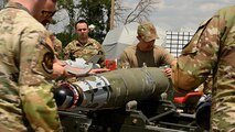 Airmen oversee a munitions build.