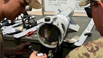 Two Airmen discuss their plan for a munitions build.