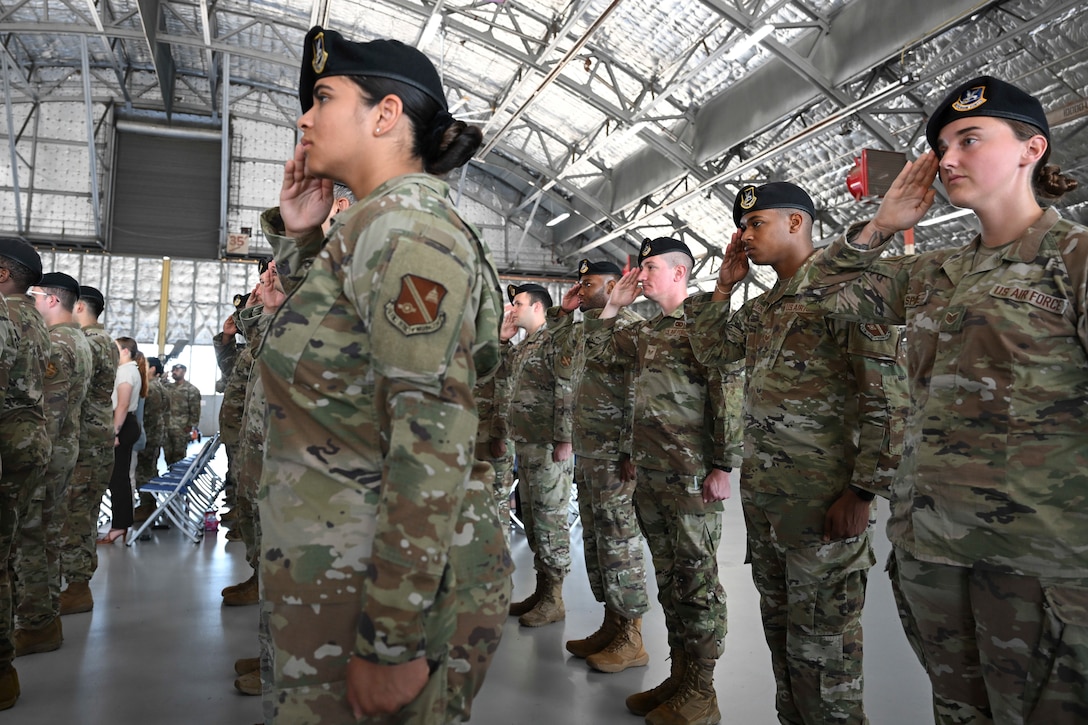 Airmen assigned to the 316th Security Forces Group render a salute during the unit’s change of command at Joint Base Andrews, Md., July 3, 2025. The event marked the transfer of command from Col. Michael J. Morales to Col. Joseph A. Bincarousky Sr.