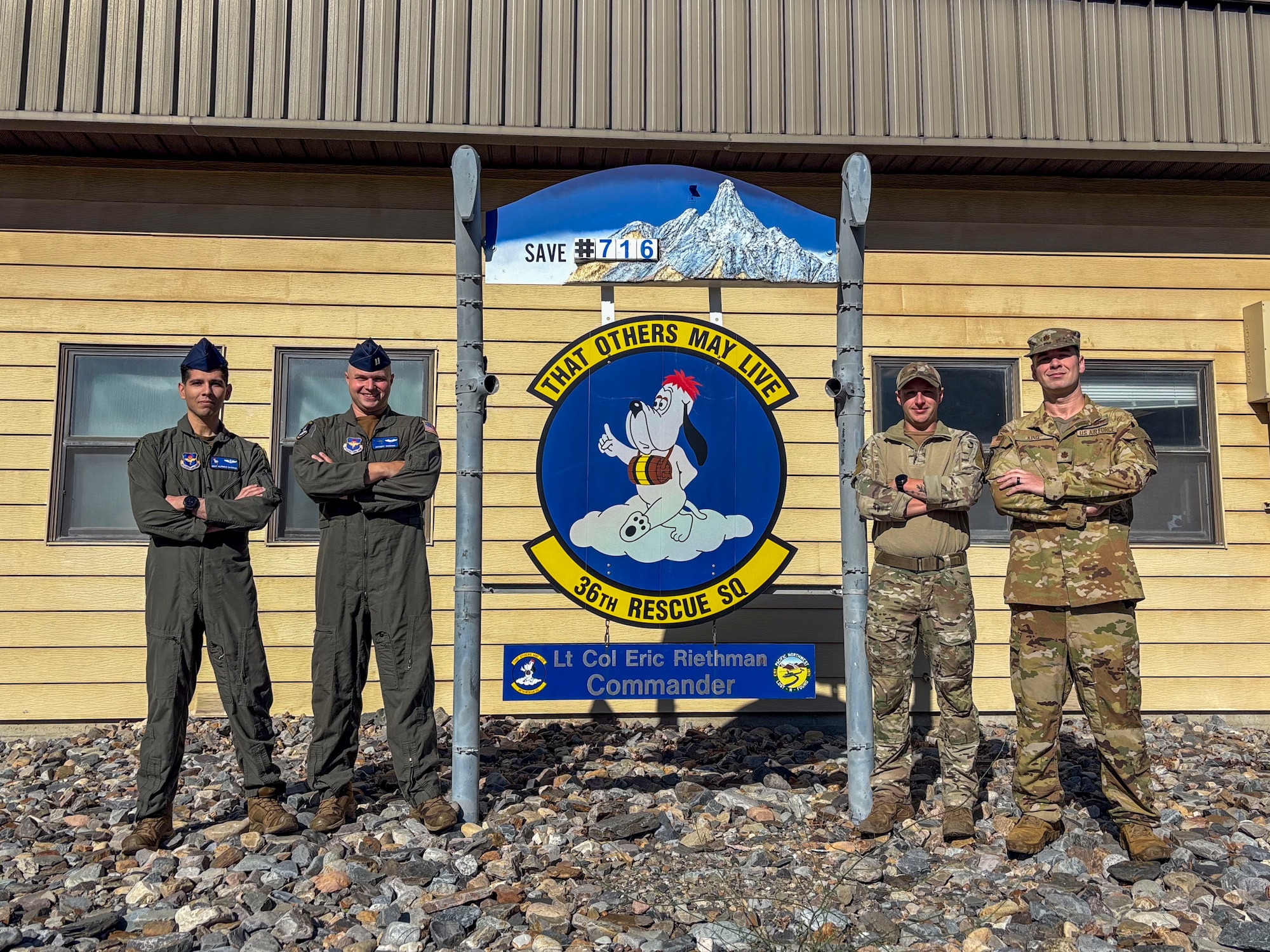 people posing in front of sign
