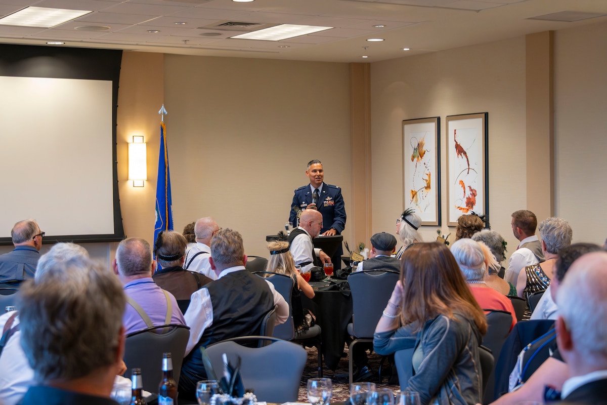Col. Martinez stands before members of the 307th Bombardment Group during their reunion dinner to offer a speech.