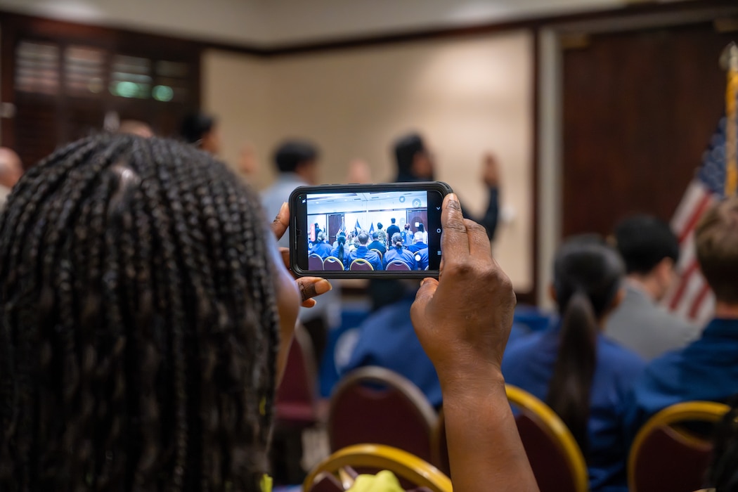Woman records ceremony with phone