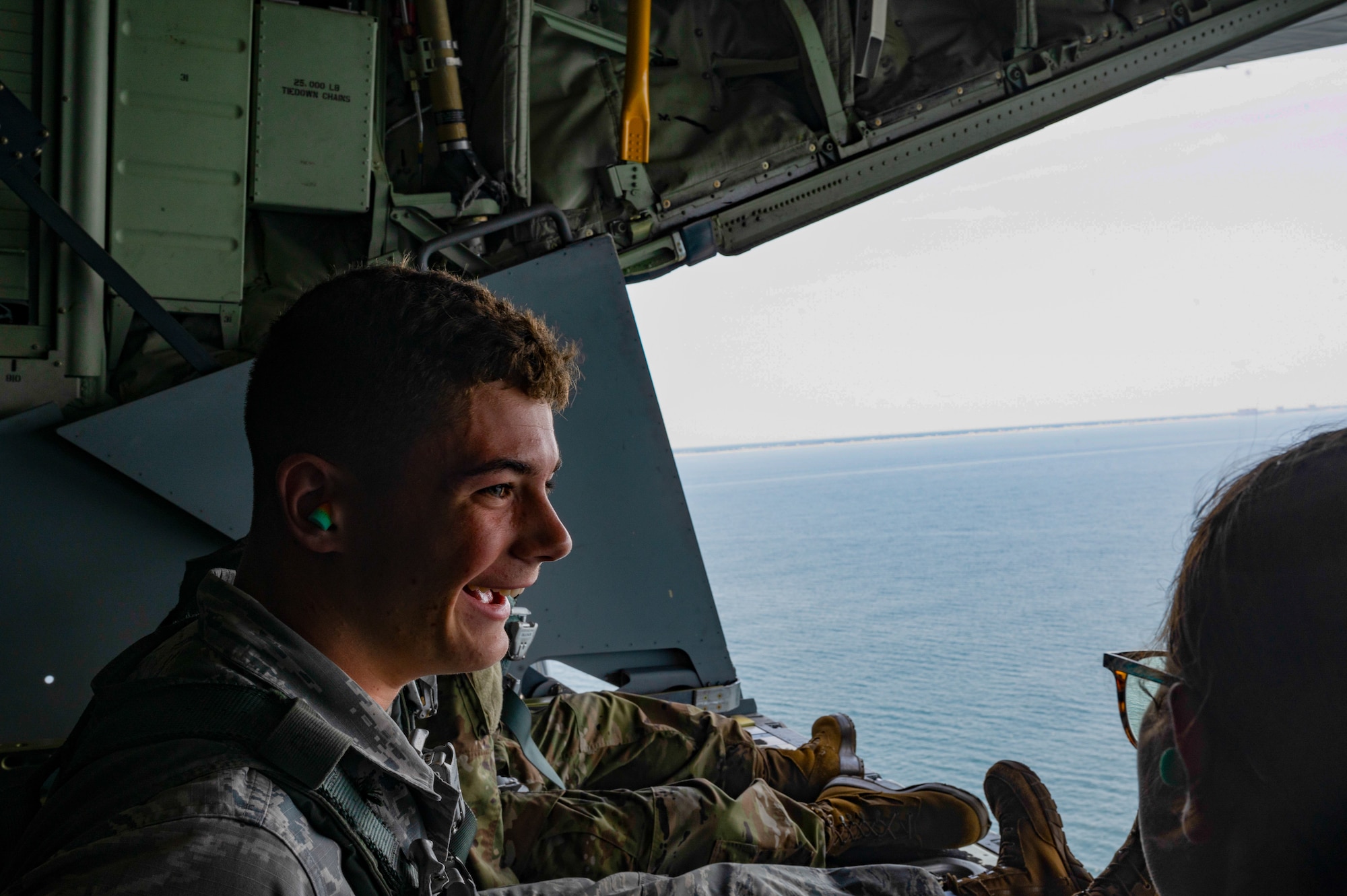 U.S. Air Force Junior ROTC cadets sit on the ramp of a MC-130J Commando II assigned to the 1st Special Operations Wing during an orientation flight near Hurlburt Field, Florida, June 25, 2025.