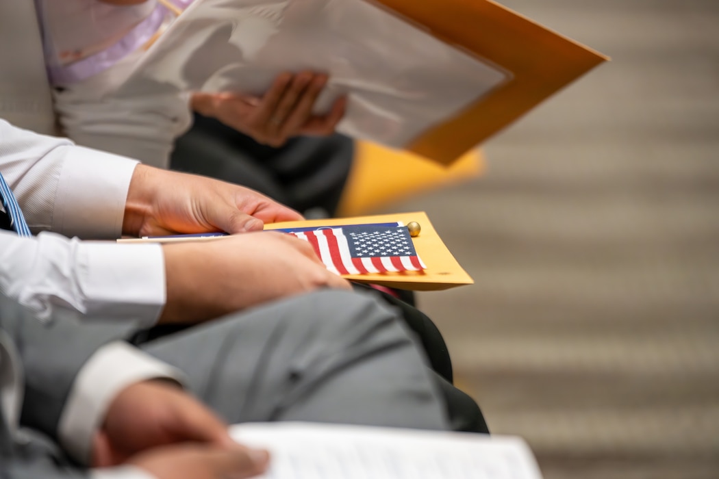 Man holds American flag at ceremony