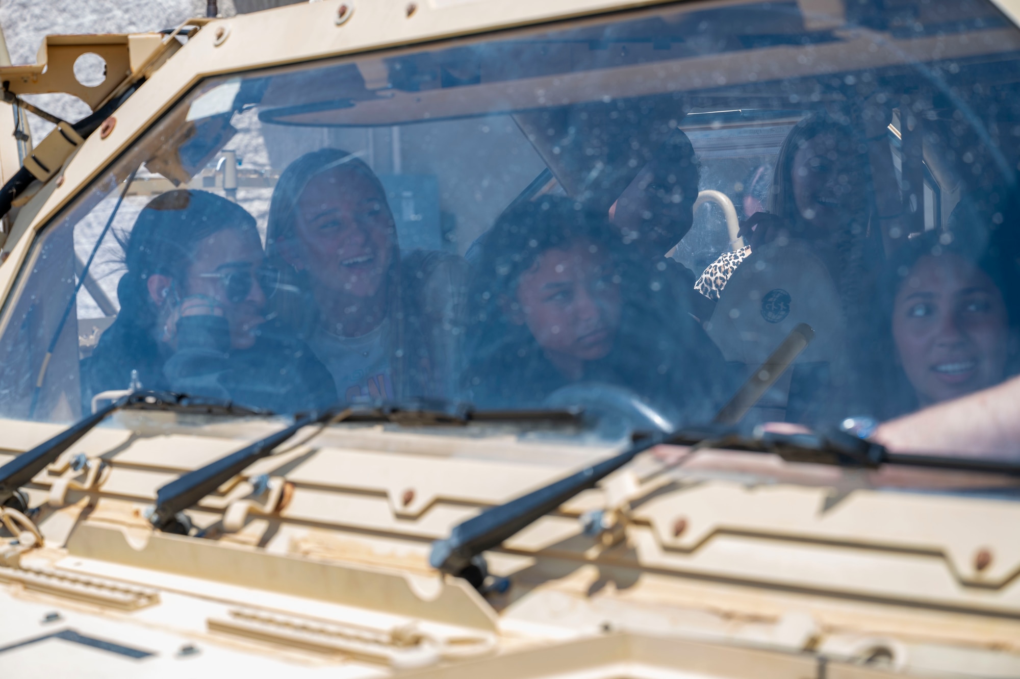 Students from Fort Walton Beach High School sit inside of a M1288 government motor vehicle 1.1 during a tour at Hurlburt Field, Florida, May 8, 2025.