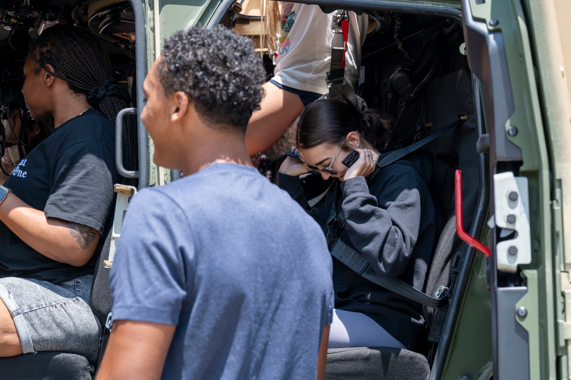 Students from Fort Walton Beach High School sit inside of a joint light tactical vehicle during a tour at Hurlburt Field, Florida, May 8, 2025.