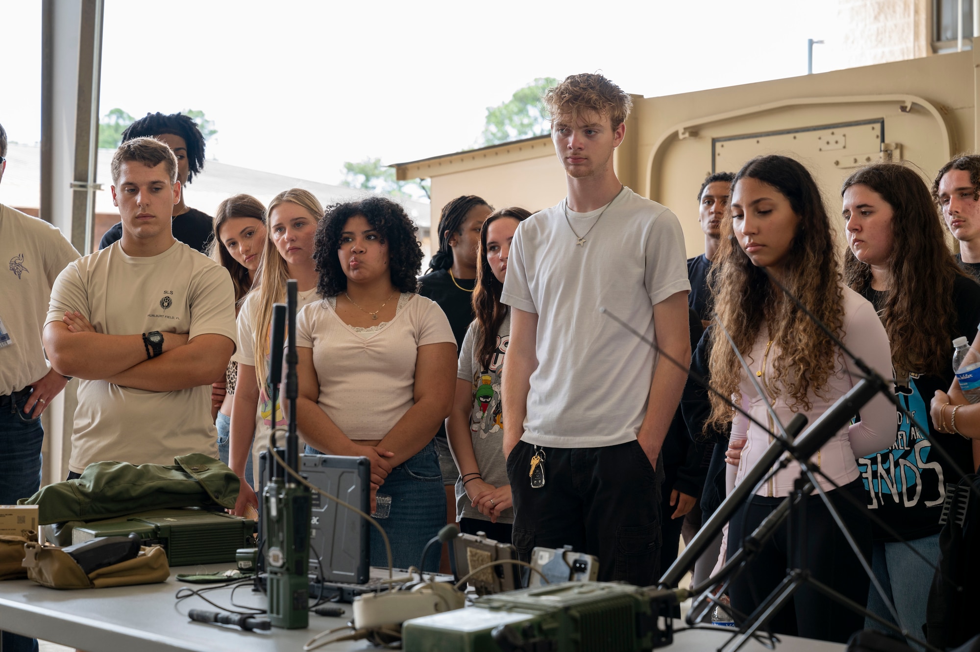 Students from Fort Walton Beach High School are briefed on tactical communications equipment during a tour at Hurlburt Field, Florida, May 8, 2025.