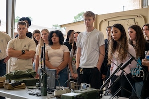Students from Fort Walton Beach High School are briefed on tactical communications equipment during a tour at Hurlburt Field, Florida, May 8, 2025.