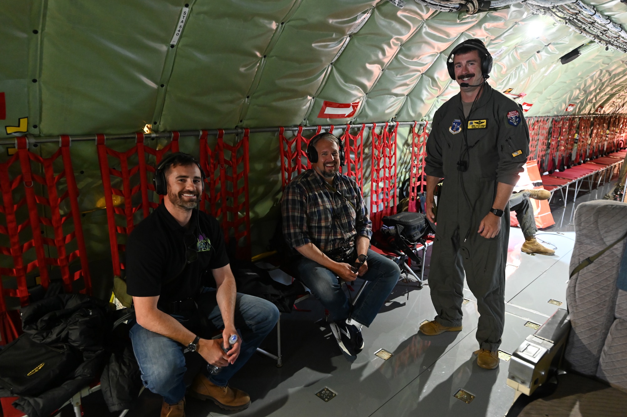 Senior Master Sgt. Keith Rowan, boom operator with the 168th Air Refueling Squadron, talks with North Pole Mayor Larry Terch and Dean Baxter from Fairbanks International Airport Operations aboard an Alaska Air National Guard KC-135 Stratotanker during a Civic Leader Flight.
