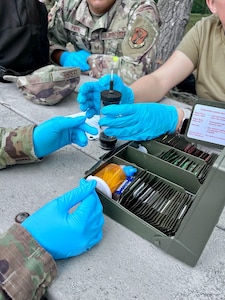 Tech. Sgt. Jazzmin Tristan, a Public Health technician with the 168th Wing, Alaska Air National Guard, and her Air National Guard counterparts test a water sample for potential biological and chemical hazards