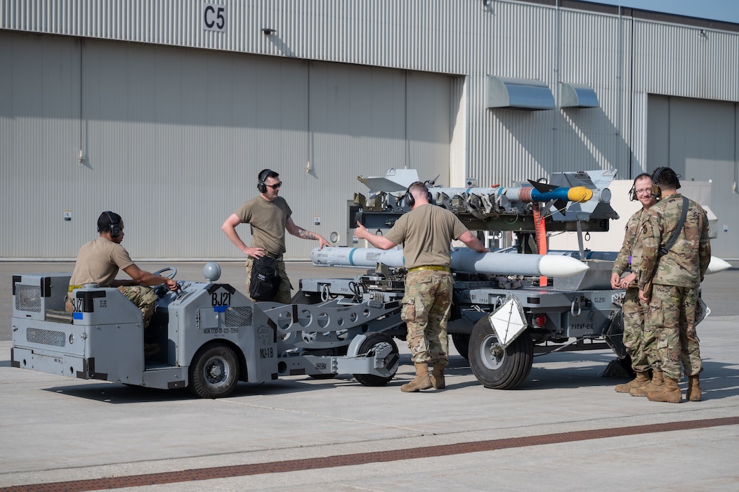 U.S. Air Force Airmen from the 18th Fighter Generation Squadron, transport an inert AIM-120 Advanced Medium Range Air-to-Air Missile during the second quarter load competition at Eielson Air Force Base, Alaska, July 3, 2025.