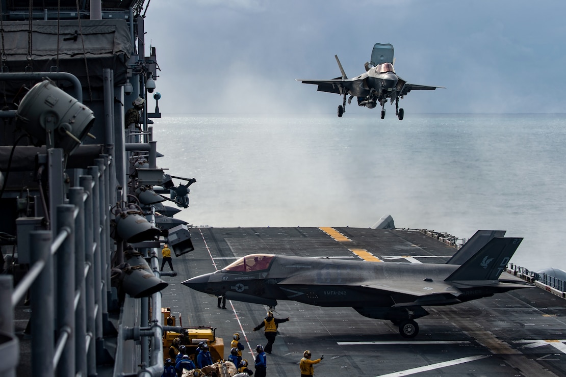 A U.S. Marine F-35B Lightning II aircraft from Marine Fighter Attack Squadron (VMFA) 242, 31st Marine Expeditionary Unit, prepares to land on the flight deck of the forward-deployed amphibious assault ship USS America (LHA 6) during flight operations in the Coral Sea, June 29.