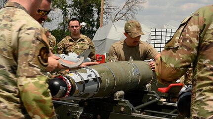 Airmen oversee a munitions build.