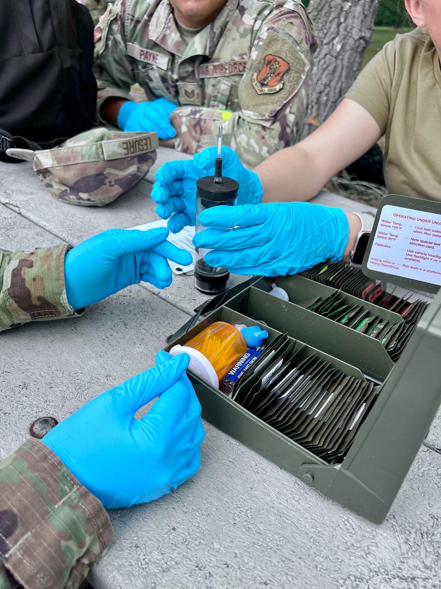 Tech. Sgt. Jazzmin Tristan, a Public Health technician with the 168th Wing, Alaska Air National Guard, and her Air National Guard counterparts test a water sample for potential biological and chemical hazards