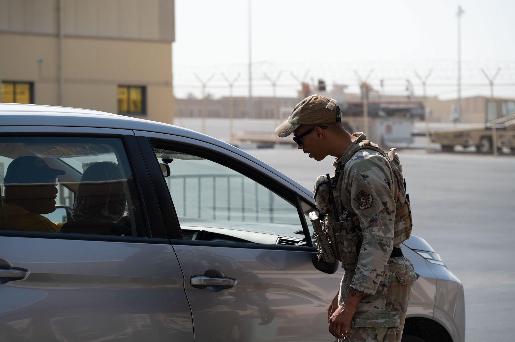 U.S. Air Force Senior Airman Cameron Gay, 379th Expeditionary Security Forces Squadron patrolman, checks credentials at an entry control point within the U.S. Central Command area of responsibility, June 17, 2025. Members of the 379 ESFS are prepared to provide defense anywhere in the world with short notice. (U.S. Air Force Photo by Senior Airman Dieondiere Jefferies)