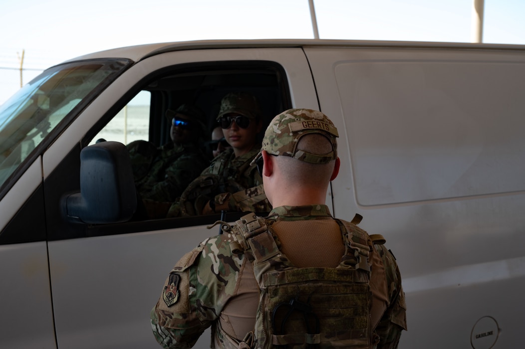 U.S. Air Force Senior Airman Joseph Geerts, 379th Expeditionary Security Forces Squadron patrolman, checks credentials at an entry control point within the U.S. Central Command area of responsibility, June 17, 2025. The 379th ESFS is responsible for the security of personnel and the protection of resources on the installation. (U.S. Air Force Photo by Senior Airman Dieondiere Jefferies)
