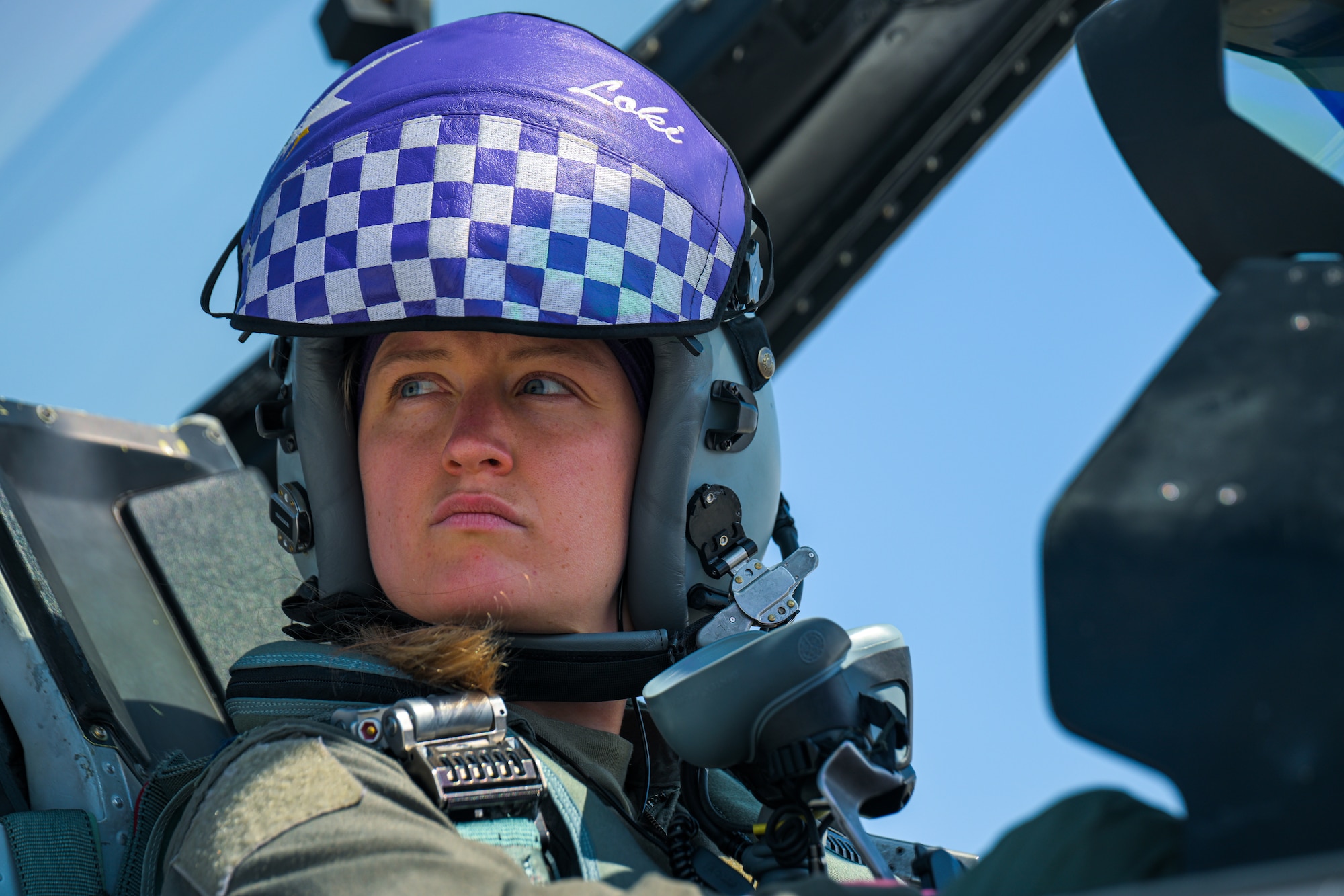 A pilot sits in an F-16 cockpit.
