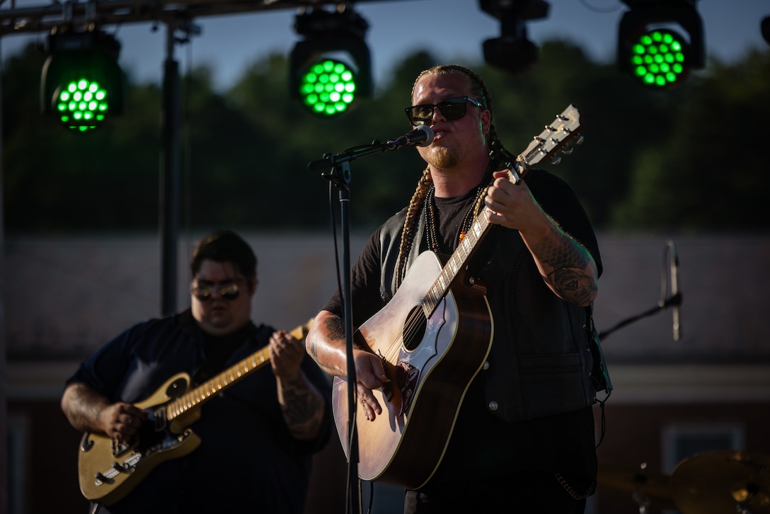 Michael Huntley, an American blues rock singer-songwriter and winner of The Voice season 24, performs for attendees of Marine Corps Base Quantico’s Fourth of July celebration at Lejeune Field, MCB Quantico, Virginia, July 3, 2025. The event hosted a multitude of outdoor activities for families, friends and service members to include; bouncy house obstacle courses, a rock climbing wall, and games such as corn hole. The celebration featured a live performance from artist Huntley and ended in a firework show. (U.S. Marine Corps photo by Cpl. Darien Wright)
