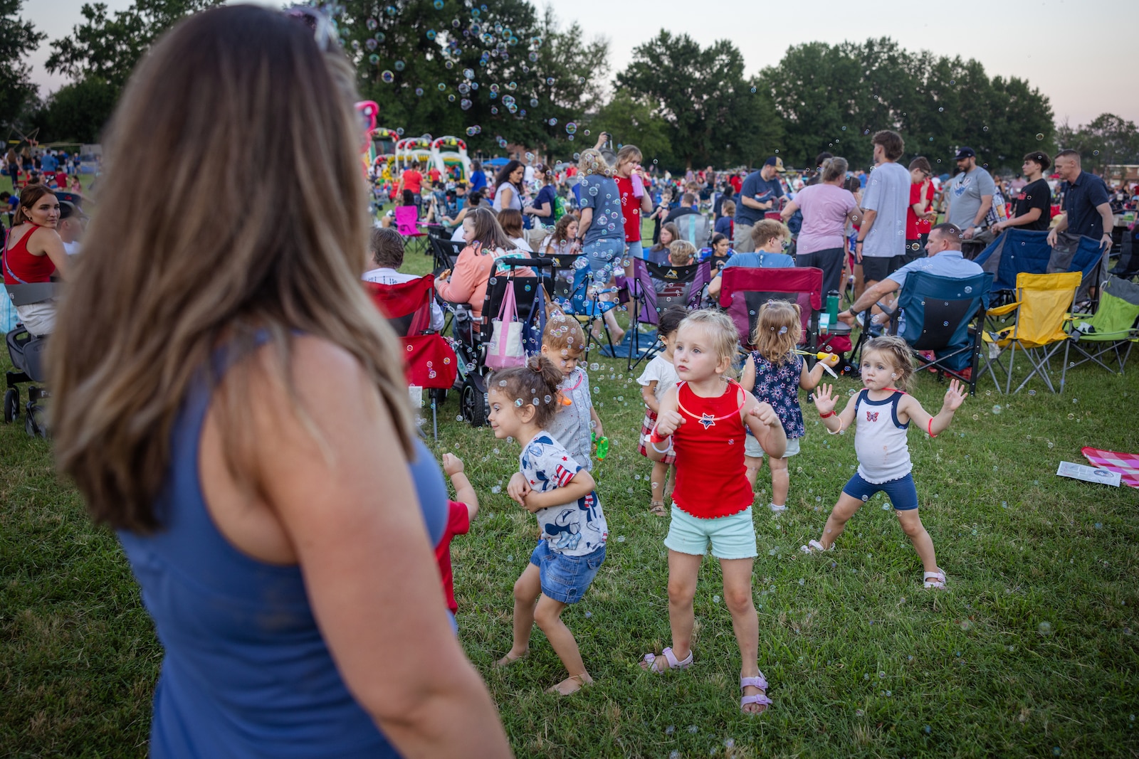 A group of kids with bubbles during Marine Corps Base Quantico’s Fourth of July celebration at Lejeune Field, MCB Quantico, Virginia, July 3, 2025. The event hosted a multitude of outdoor activities for families, friends and service members to include; bouncy house obstacle courses, a rock climbing wall, and games such as corn hole. The celebration featured a live performance from artist Huntley, the winner of The Voice’s season 24 and ended in a firework show. (U.S. Marine Corps photo by Cpl. Darien Wright)