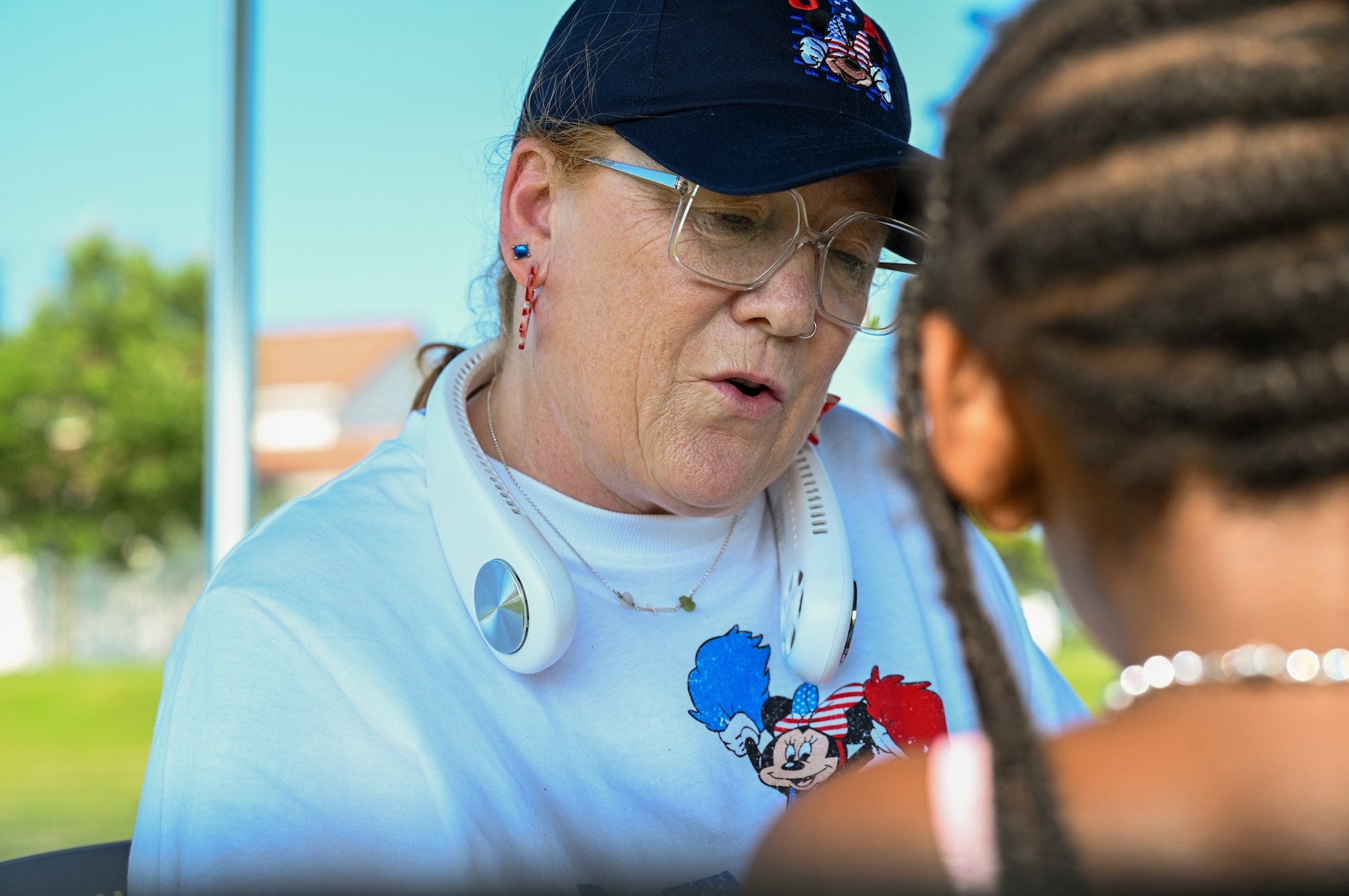 Wendy Thompson gives a glitter temporary tattoo to Athena Toussaint at Freedom Fest at JBAB on July 4, 2025.