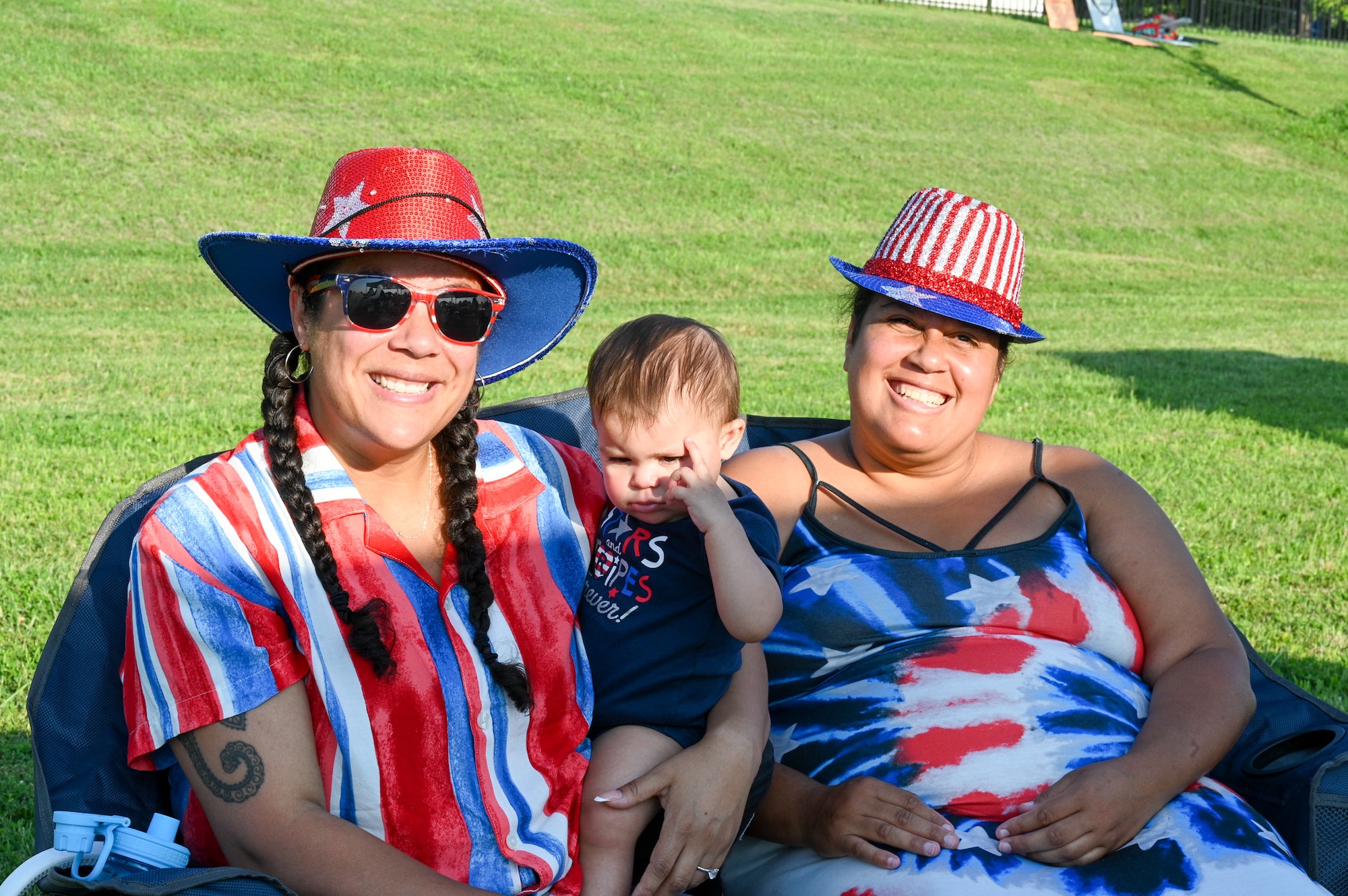 U.S. Air Force Senior Master Sgt. Wedny Lewis, Legislative Liason at the Pentagon, (left) and her daughter, Lena Lewis and sister Vanessa Montellese, gather for a photo in celebration of the Independence Day during  Freedom Fest at Joint Base Anacostia-Bolling, Washington, D.C., July 4, 2025.