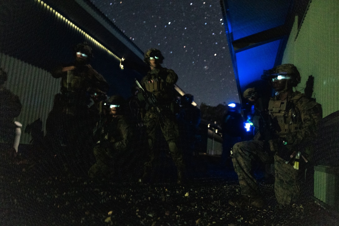 U.S. Marines with Force Reconnaissance Platoon, Maritime Raid Force, 31st Marine Expeditionary Unit, conduct platoon level coordination on the objective during a limited scale raid exercise at Sam Hill Airfield, Queensland, Australia, July 1, 2025. Following a ship-to-shore insert, the Marines conducted the limited scale raid night exercise to demonstrate operational proficiency. The 31st MEU is operating aboard ships of the USS America Amphibious Ready Group in the 7th Fleet area of operations, the U.S. Navy’s largest forward-deployed numbered fleet, and routinely interacts and operates with allies and partners in preserving a free and open Indo-Pacific region. (U.S. Marine Corps photo by Cpl. Alora Finigan)