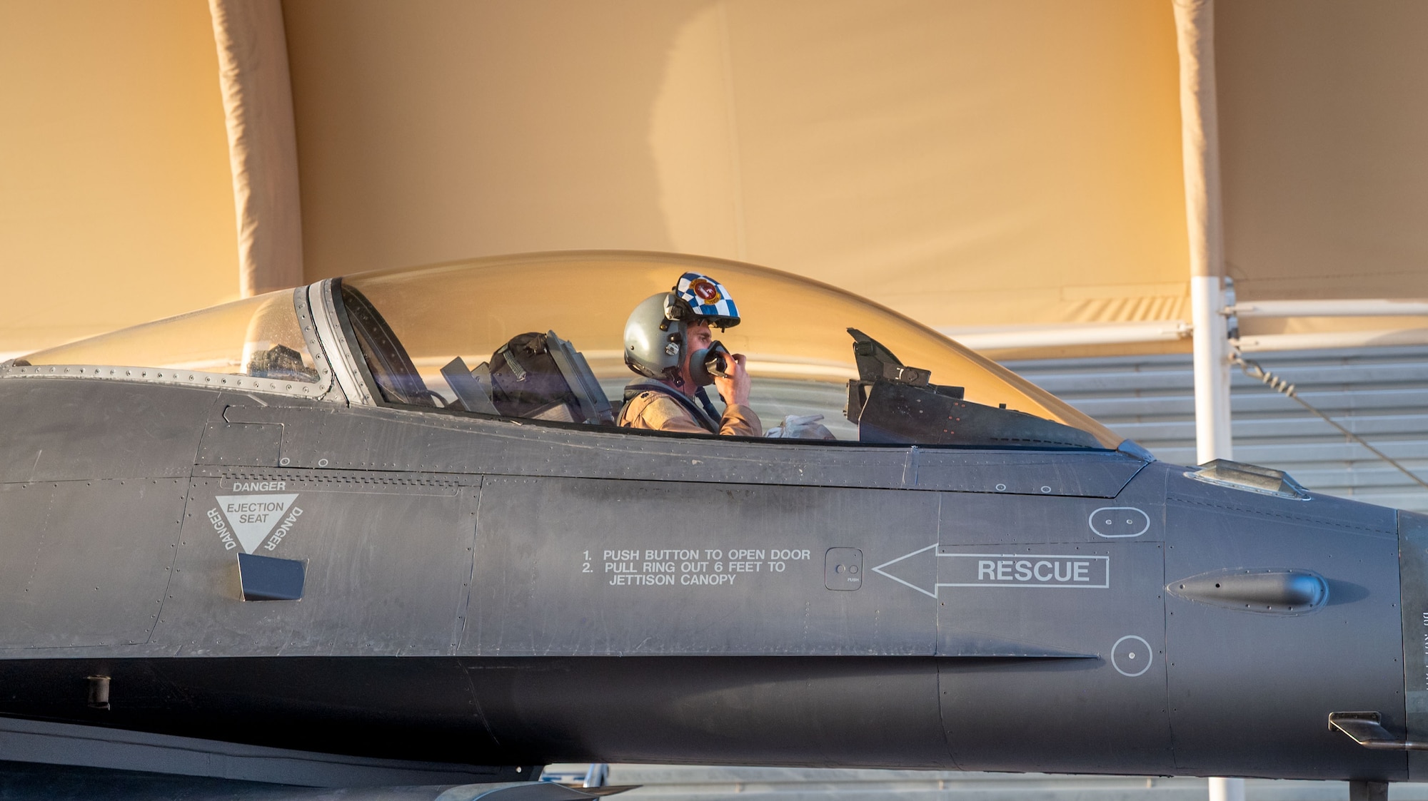 A pilot sits in an F-16C Fighting Falcon.
