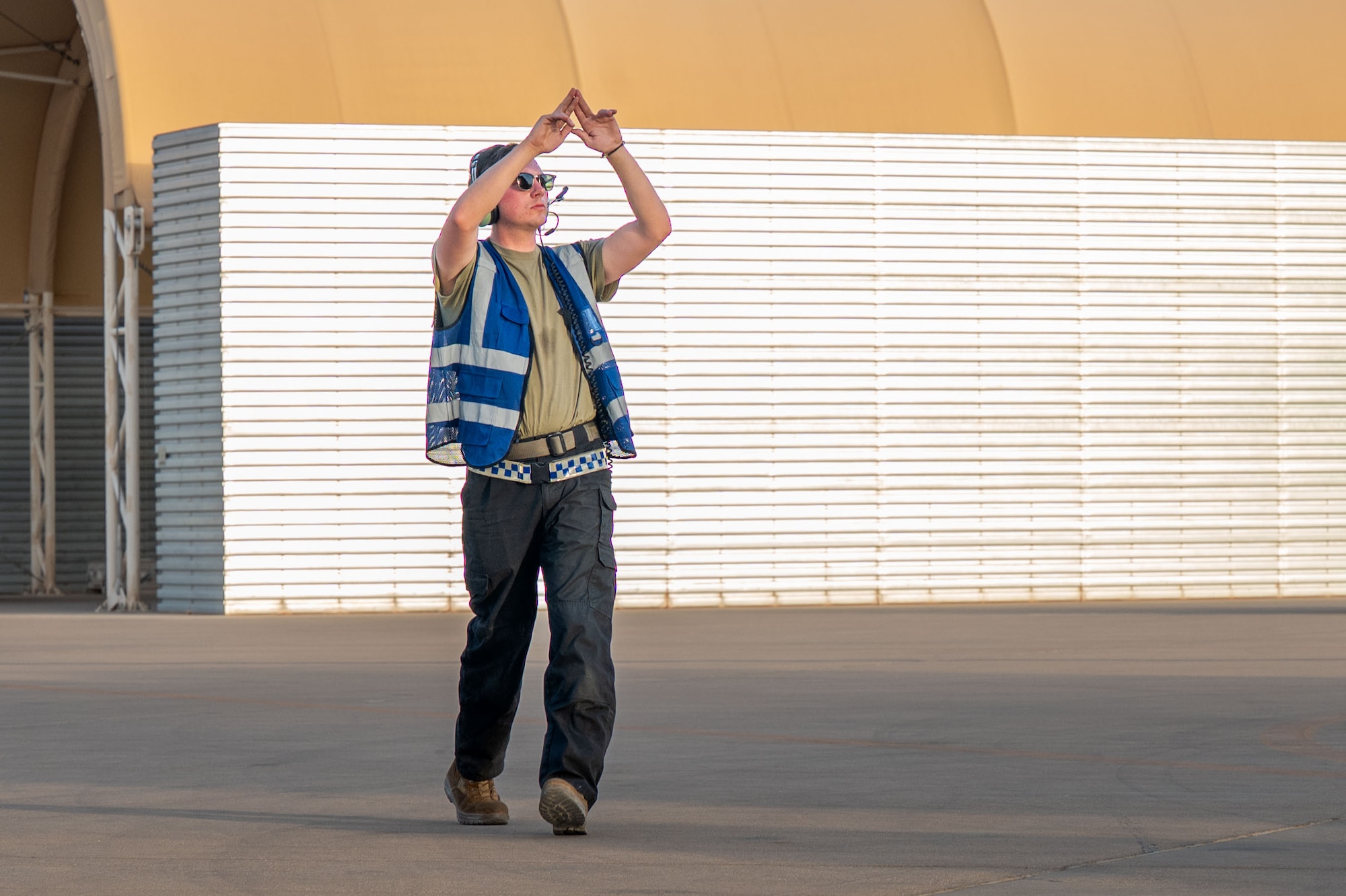 A man marshals an aircraft.