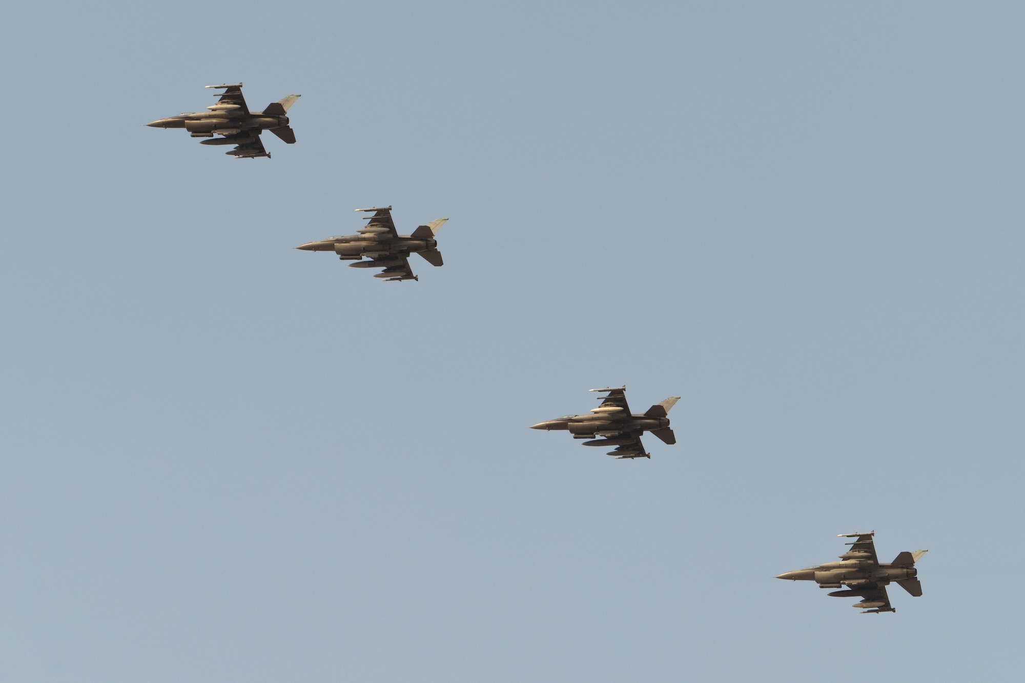 Four U.S. Air Force F-16C Fighting Falcons assigned to the 555th Expeditionary Fighter Squadron conduct an initial approach.